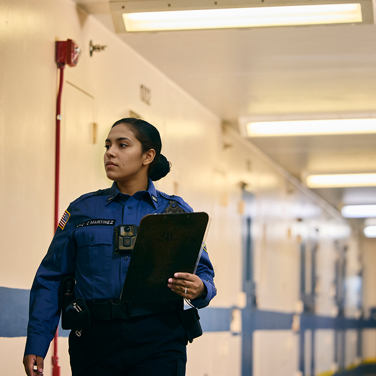 photo of a corrections officer knocking on a cell door